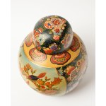 A ceramic, bulbous vase with a lid, known as the Elephant, most likely comes from Japan.