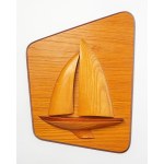 A wall decoration depicting a boat or yacht, made of wood.