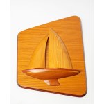 A wall decoration depicting a boat or yacht, made of wood.