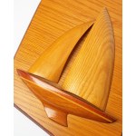 A wall decoration depicting a boat or yacht, made of wood.