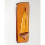 A wall decoration depicting a boat or yacht, made of wood.
