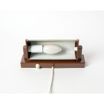 A wall lamp made of plastic. It works great as a reading lamp, and you can adjust the angle of the light. Made in Denmark.