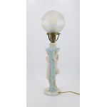 A lamp with a base featuring a faun and a nymph