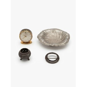An assortment of decorative metal items and a Jaeger travel clock