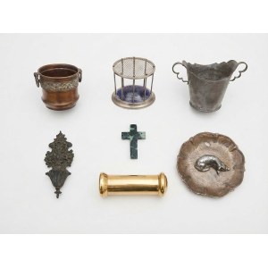A collection of decorative metal objects, including copper, brass, pewter, and bronze