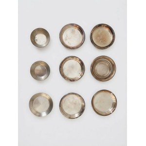 A set of nine silver-plated bowls and saucers