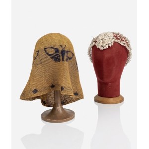 Set of two vintage hats on display stands.