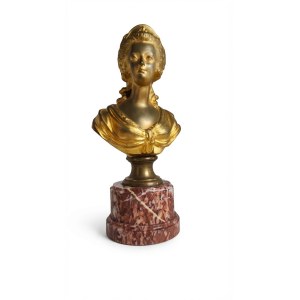 A female bust made of gilded metal on a base of veined red marble