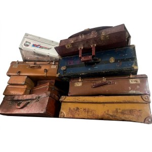 A collection of vintage and antique suitcases and trunks from the 20th century