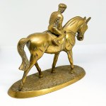 A brass statue depicting a rider on a horse