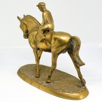 A brass statue depicting a rider on a horse