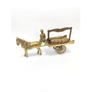 A brass figurine depicting a coal merchant