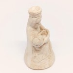 A plaster figurine of Michelangelo's *La Pietà*, signed