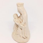 A plaster figurine of Michelangelo's *La Pietà*, signed