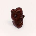 Handcrafted wooden figurine of the God of Fertility