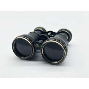 A vintage Le Sportsman binocular with a compass