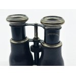 A vintage Le Sportsman binocular with a compass