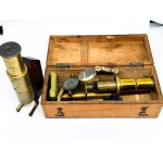 Two antique brass microscopes, one in a box