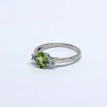 Silver ring with a natural peridot and white sapphires