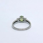 Silver ring with a natural peridot and white sapphires