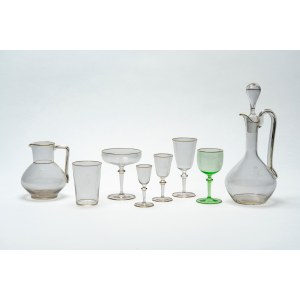 Crystal glass set with gold trim and an engraved crowned monogram.