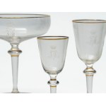 Crystal glass set with gold trim and an engraved crowned monogram.