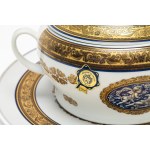 Two-handled porcelain soup tureen with a plate featuring blue and gold trim and leaf swirls. Limoges.