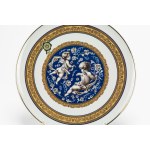 Two-handled porcelain soup tureen with a plate featuring blue and gold trim and leaf swirls. Limoges.