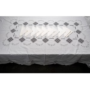 Rectangular tablecloth with ten matching white linen napkins.
