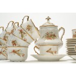 Tea set with gold handles and trim, made of white porcelain and decorated with red flowers. M. Redon, Limoges.