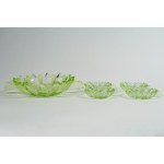 Fruit salad set consisting of a two-handled bowl and four small green glass bowls with water lily leaves.