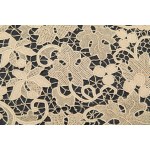 A richly decorated rectangular tablecloth featuring floral motifs in linen and lace, with twelve matching napkins