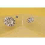 Clear glass bread basket with silver foil daisy inserts.