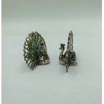 A pair of silver peacock-shaped business card holders, enamel