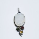 Silver pendant with a large moonstone, ruby, tourmaline, and citrine