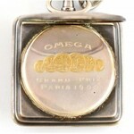 Ezüst (Ag) Omega zsebóra négyszögletes, illusztrált tokkal. Jelzett, működő állapotban, fém óralánccal ...