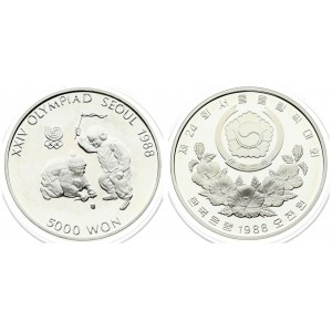 Korea-South 5000 Won 1988 1988 Olympics. Averse: Arms above floral spray. Reverse: Boys spinning top. Silver...