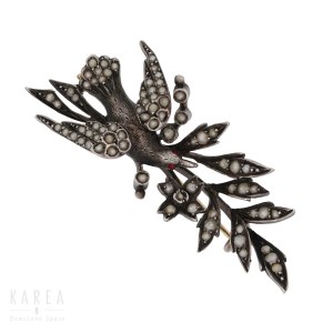 A brooch modelled as a bird with a flowering branch