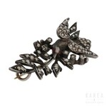 A brooch modelled as a bird with a flowering branch