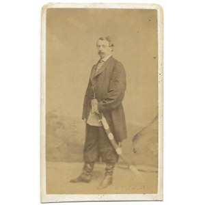 [PHOTO posed - a man with a parade rifle at his side]. [not after 1867]. Photograph form. 9x5,...
