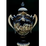 Decorative relief vase with two side handles and a lid