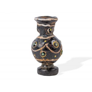 Phoenician sand core glass, In the form of a vase, Damaged, restored