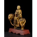 A GILT WOOD LOHAN ON A ELEPHANT