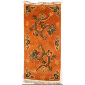 AN ORANGE GROUND CARPET WITH DRAGONS