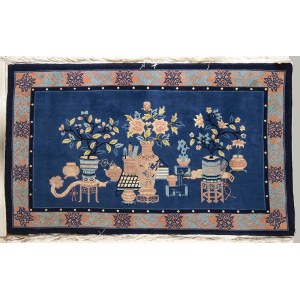 A BLUE GROUND CARPET WITH OBJECTS AND FLOWERS
