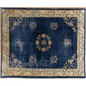 A BLUE GROUND CARPET WITH FLORAL MOTIFS