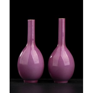 A PAIR OF RUBY GLAZED PORCELAIN SMALL BOTTLE VASES