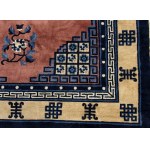 A PINK GROUND CARPET WITH A POLYCHROME DECORATION OF CHARACTERS, SYMBOLS AND STYLIZED FLORAL MOTIFS