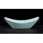 A TURQUOISE GLAZED AND SLIP DECORATED PORCELAIN INGOT-SHAPED BOWL