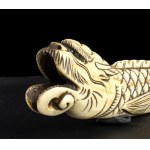 A STAG HORN NETSUKE WITH A FANTASTIC ANIMAL